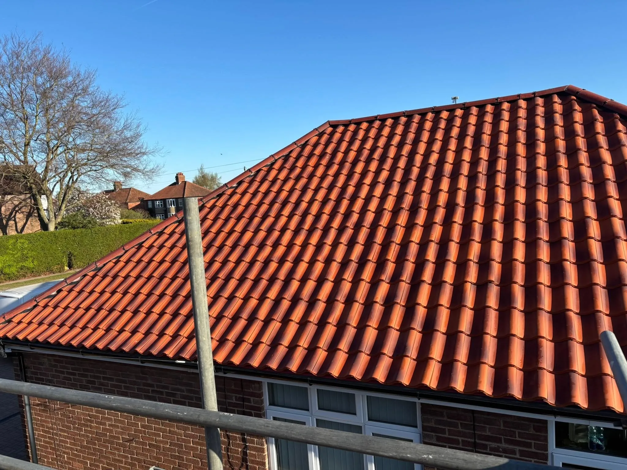 Finished pantile re-roof on a Norwich home under blue sky