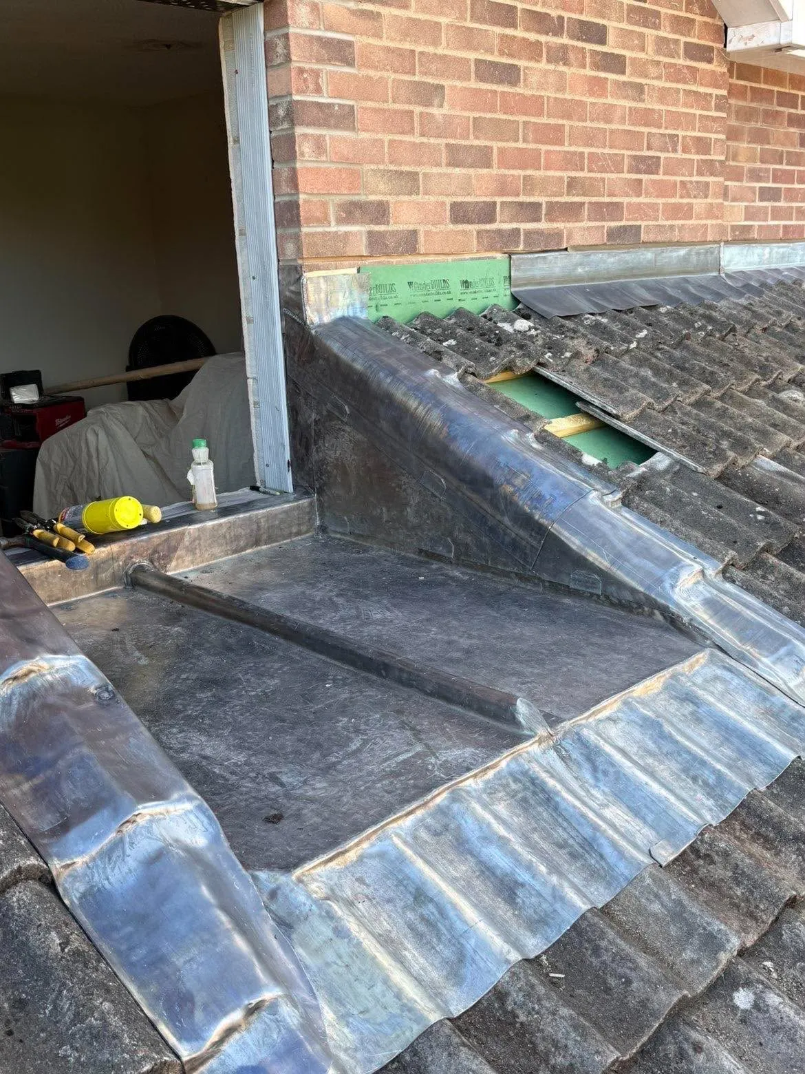 New lead flashing dressed and sealed to a tiled roof